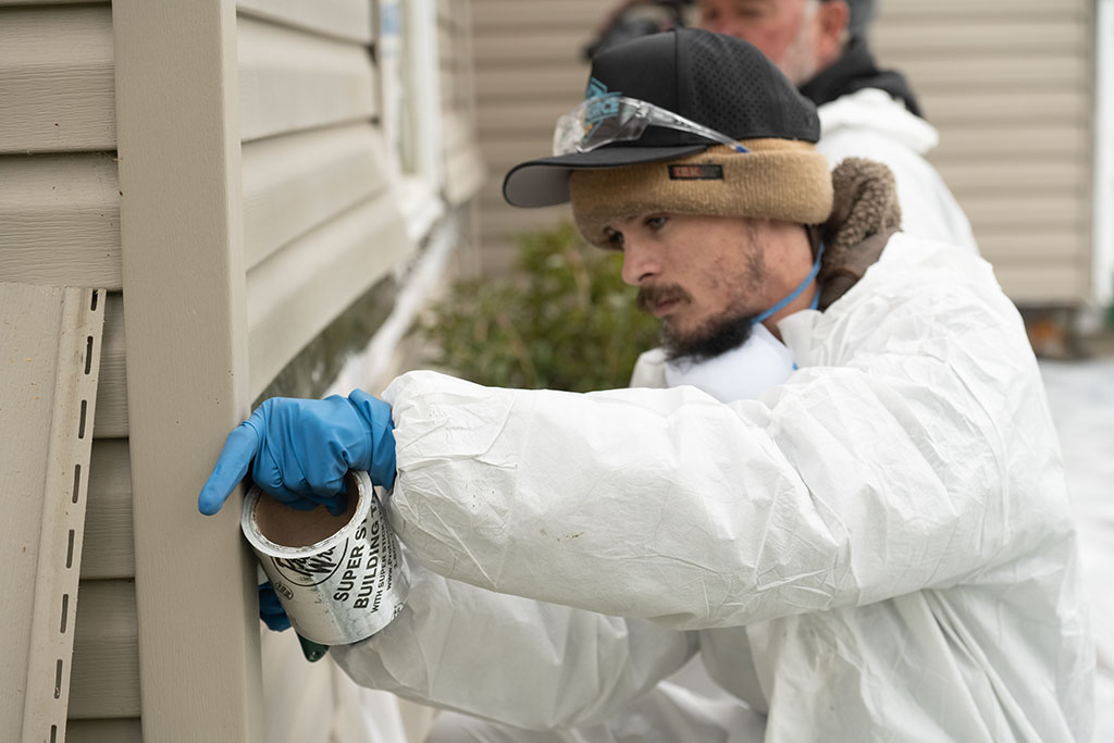 WxForce worker helping to add siding to a home