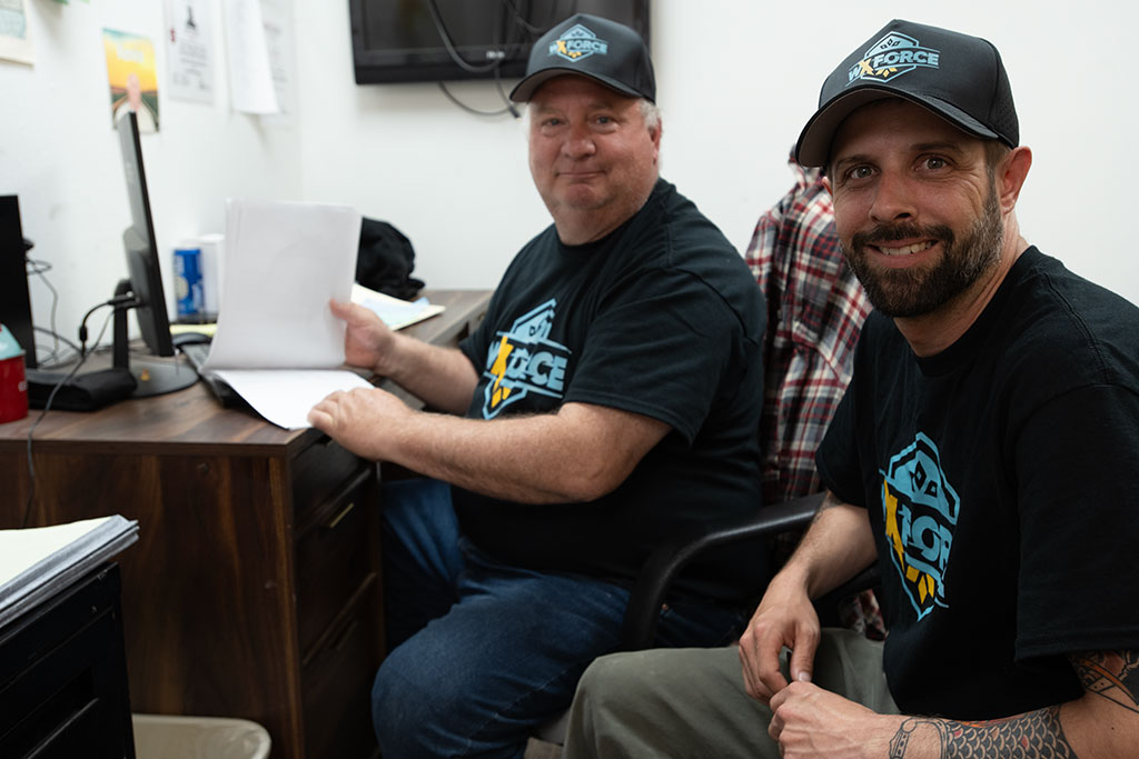 two WxForce team members sitting in an office