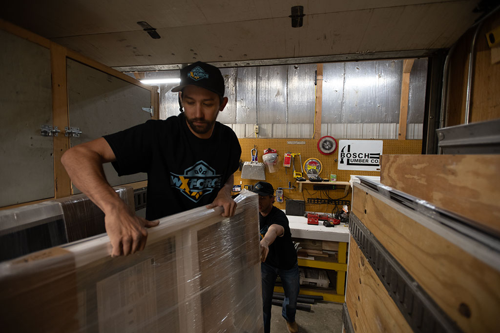 worker in trailer carrying weatherization materials