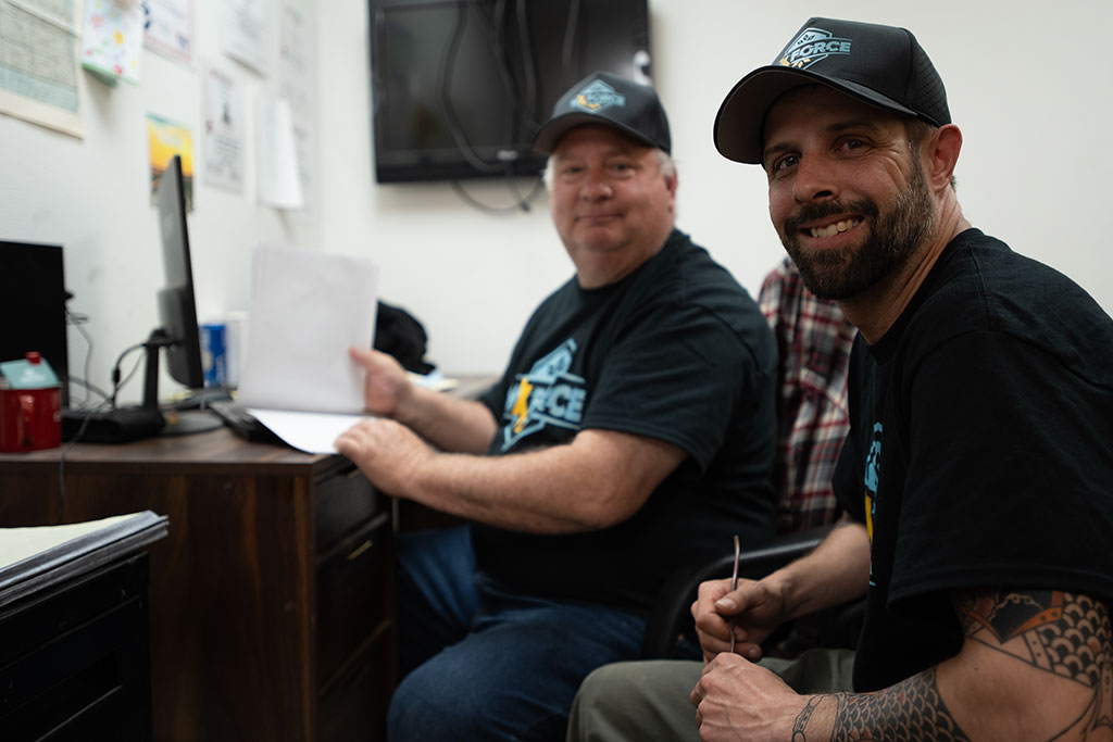 two WxForce team members sitting in an office